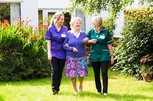 SureCare Salford and Manchester, carers with elderly lady in garden 