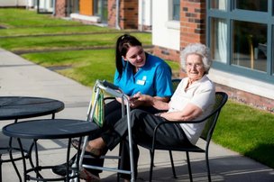 Resident and care in the garden of Monkbarns Care home in Arbroath