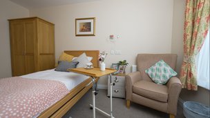 Ledbury Nursing Home - Modern bedroom with bed and armchair