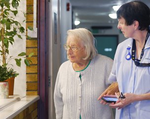 Plas Cae Crwn Care Home - resident and carer walking together