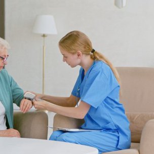 Prestige Care Solutions, Northampton. Carer doing some tests on elderly mans health 