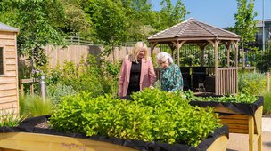 Cotswold Gate in Burford, Carer and resident in the garden