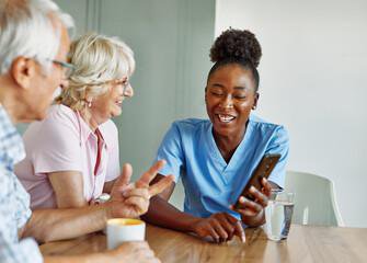 EverCare Personal Service Carer having tea with clients