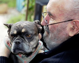 Orchard House - resident hugging dog