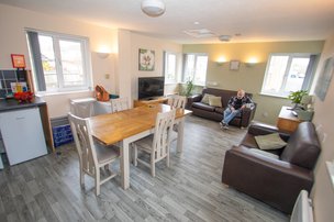Maes-y-dderwen - Communal area with seating, tables and kitchenette