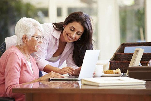 Keeplivin Care in Leicester carer helping client on computer