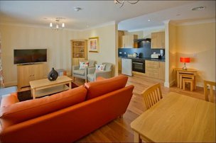 The Oaks Care Facility, lounge area with orange sofa 