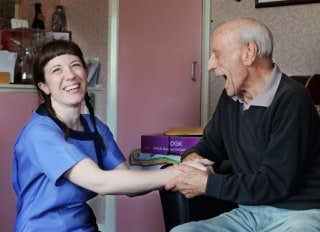 Kare Plus Kingston, Carer laughing with elderly