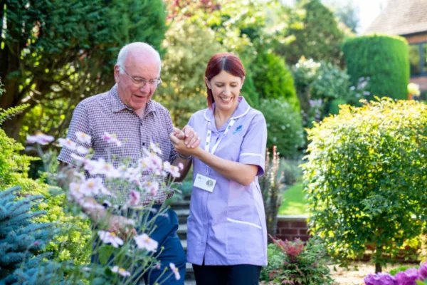 Radfield Home Care in Shrewsbury live in elderly gentleman walking with carer