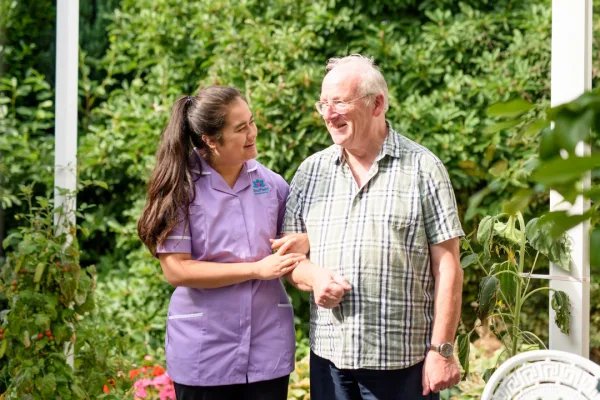 Radfield Home Care Watford & Borehamwood Live in carer walking with client