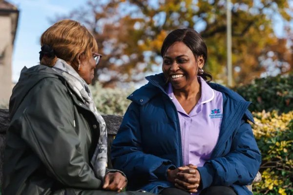 Radfield Home Care Watford & Borehamwood carer on bench with client