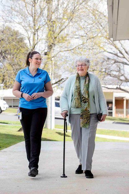 District Home Care, Carer walking with elderly