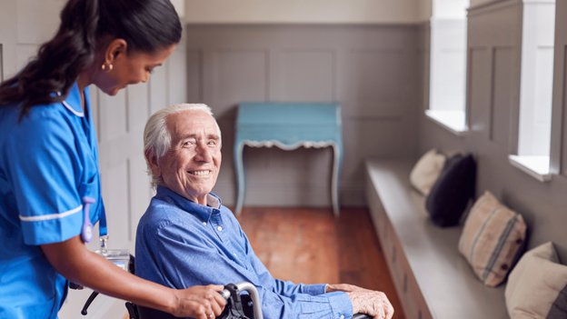 Prestige Care Solutions, Northampton. Carer helping elderly man in wheelchair. 