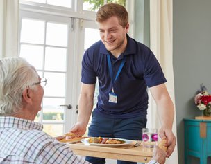 Wilson's Care in Essex carer being served meal