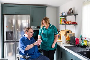 SureCare Cheshire, Care helping client in the kitchen