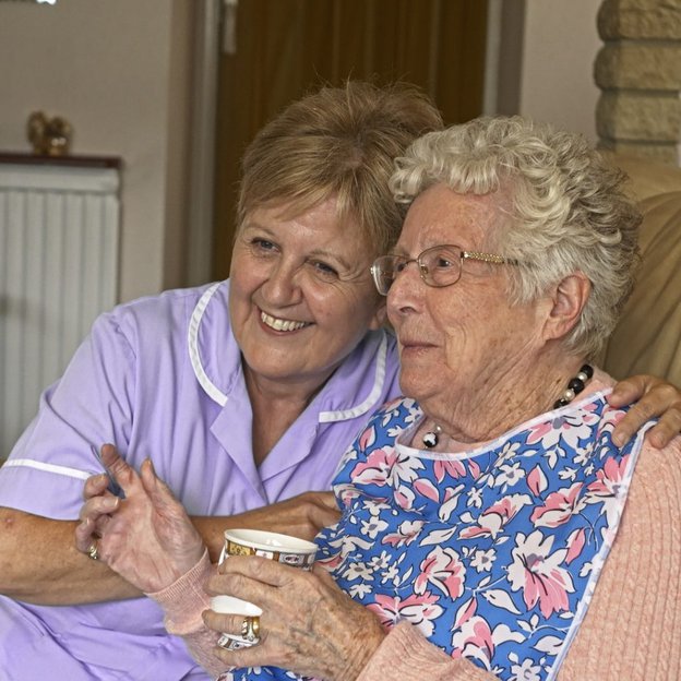 Ultima Care & Nursing, Ashford, carer laughing with elderly lady 