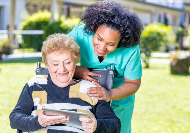 Adefey Group carer reading to lady