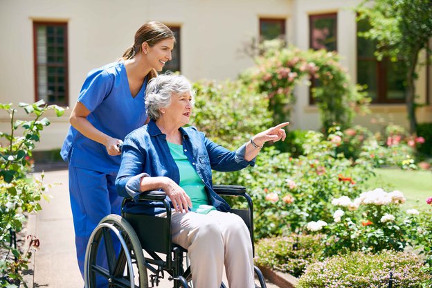 Newbirth Care, carer taking elderly into the garden