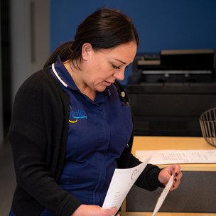 Apollo Care South Wirral - Carer looking through paperwork