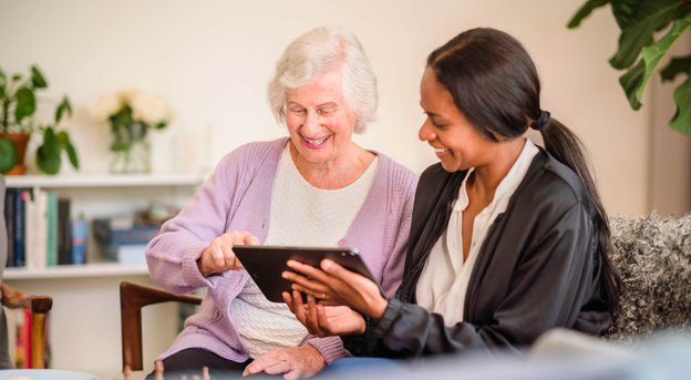 Home Instead Lichfield, Tamworth and North Warwickshire carer and client using ipad together