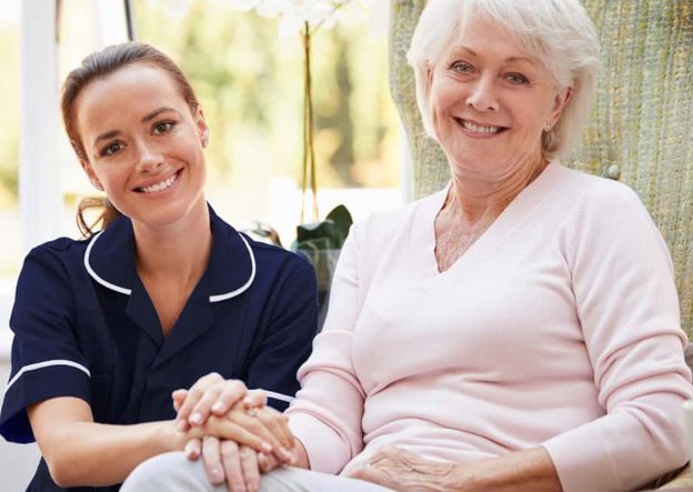 Braeburn Care Live in Care, Lady holding hands with carer. 