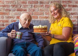 Kingsway Care Ltd carer having cake with client