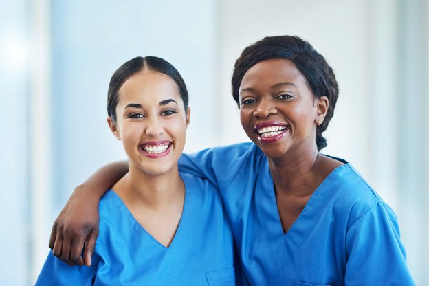 247 Blue Diamond Care, London. Two carers smiling together 