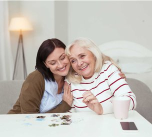 247 Blue Diamond Care, London. Carer smiling with elderly lady 