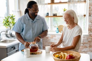 247 Blue Diamond Care, London. Carer with elderly lady having tea 