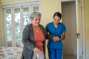 247 Blue Diamond, carer helping lady to walk 