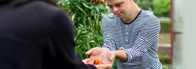 Marula Support, Birmingham, holding an apple 