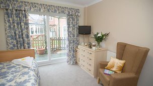 Brompton House, bedroom with window and blue curtians