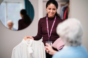 Home Instead Eastbourne and Hailsham Live in carer helping client pick out clothes