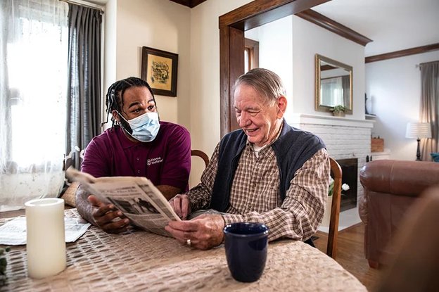 Home Instead Mansfield, Carer reading for elderly