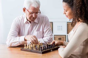 Oxford House Community Care in Slough carer playing chess with client
