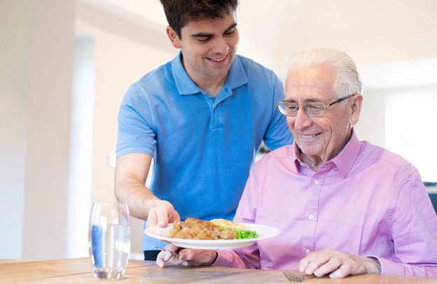 Spring Care PAs in Battle serving food to gentleman