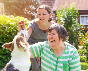 Supportive Health Ltd, Northampton, carer with client and a dog 