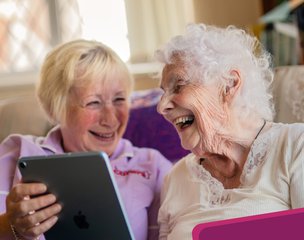 Guardian Angel Carers Reading live in, lady supporting client with ipad