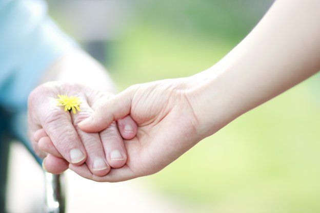 Nightingales Recruitment Care Agency in Leamington Spa, carer holding a client's hand