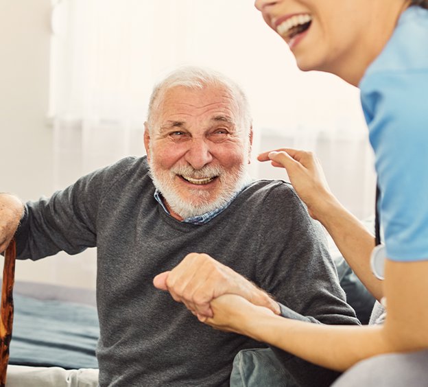 Primacy Homecare Ltd carer laughing with elderly