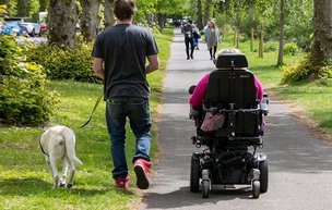 Eximius Live-in Care Limited carer on a walk with the clinet and his dog