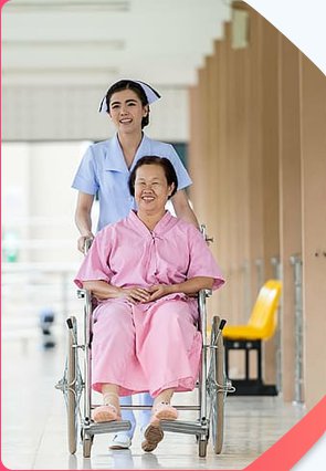 Carer pushing elderly women  - Bankplus