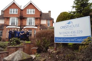 Crest House, St Leonards-on-Sea. Exterior of building with carers outside. 