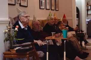 Crest House, St Leonards-on-Sea. Residents with party hats on 