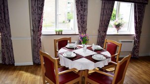 Cwrt-Clwydi-Gwyn, dining area with red chairs 