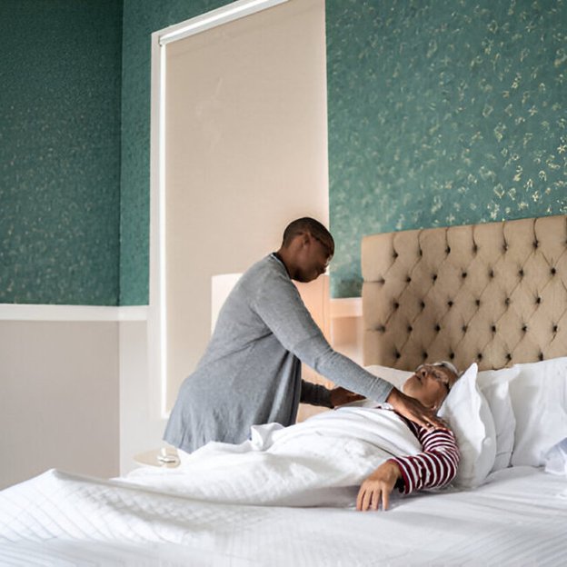 Ruby Care Services, Colchester, carer helping client in bed 