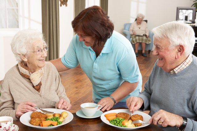 SureCare Home Care in Wolverhampton elderly couple eating dinner with carer