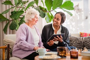 Home Instead Ruislip and Harrow Carer reading with client