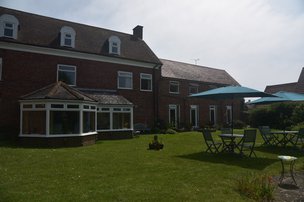 Fairways Residential Care Home in New Romney exterior of home with garden