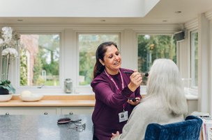 Home Instead Yeovil, Sherborne and Bridport carer doing clients make up